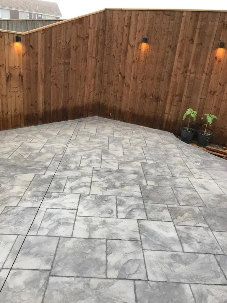 Pattern-imprinted concrete driveway with a stone-effect surface pattern.