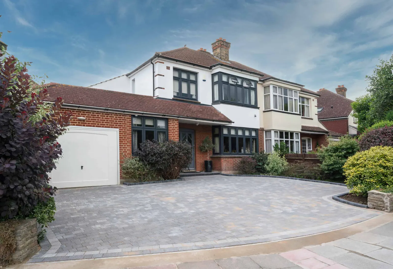 Paved driveway with defined edges and a clear parking layout.