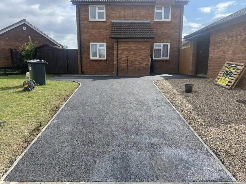 SMA tarmac driveway installation Smooth SMA tarmac driveway laid with a contrasting paved edge.